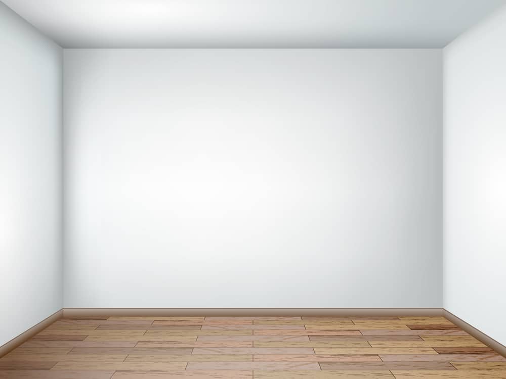 empty room with white walls and wooden floor